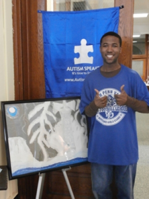 Vernon Jeffries '15 poses with the original piece of art he presented at the Conference.