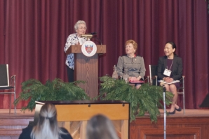 Sister Kathy Duffy opens the conference with remarks. Seated next to her are Sister Carol Jean Vale, College president, and Elizabeth Moy, director of SEPCHE